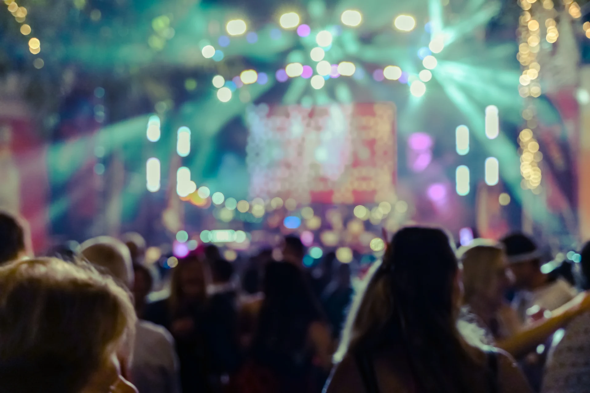 A crowd of people in front of lights.