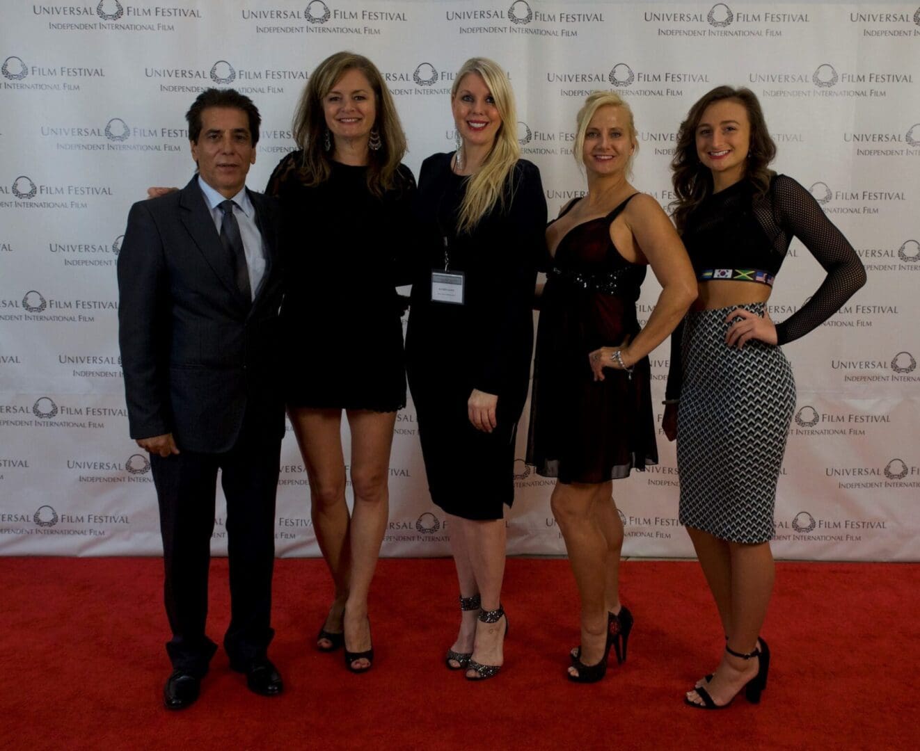 A group of people standing on the red carpet