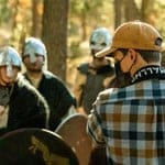 A group of people in helmets and masks are standing around.