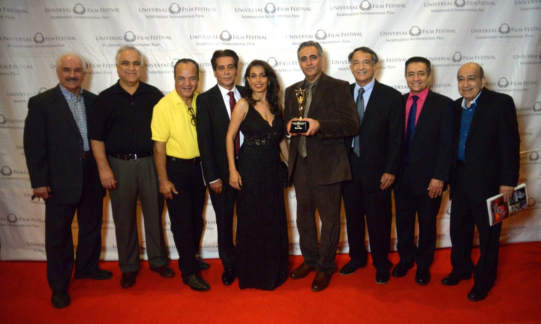 A group of people standing on the red carpet